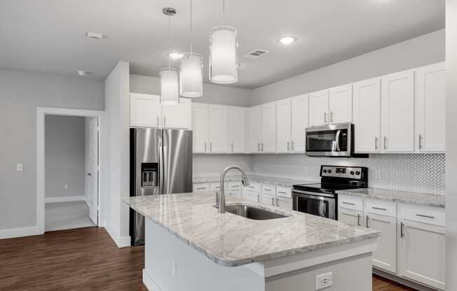 Modern kitchens with stone countertops and tile backsplash at Windsor Castle Hills, Texas