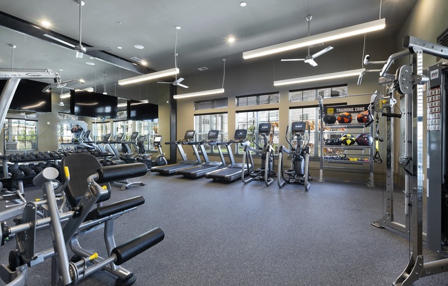 a gym with cardio equipment and weights on the floor at North Creek, Texas, 78634