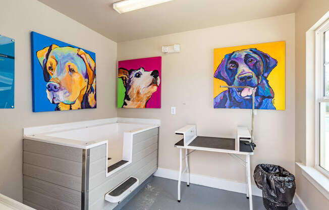 a patient room with three paintings of dogs on the wall