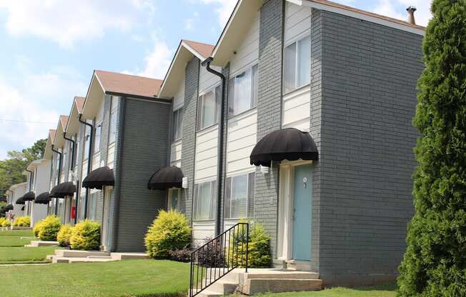 newly updated apartment home exteriors with door awnings and lush landscaping  at Huntsville Landing Apartments, Huntsville, AL, 35806