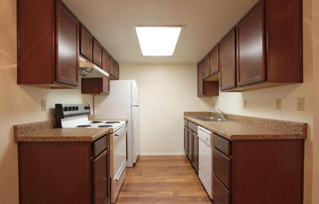 a kitchen with a stove sink and refrigerator