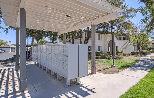 a row of mailboxes under a white awning