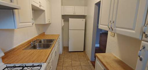 a kitchen with a sink and a refrigerator