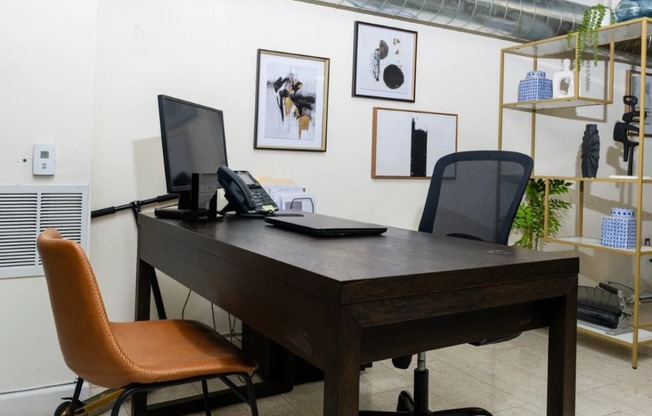 a desk with a computer and a phone in an office