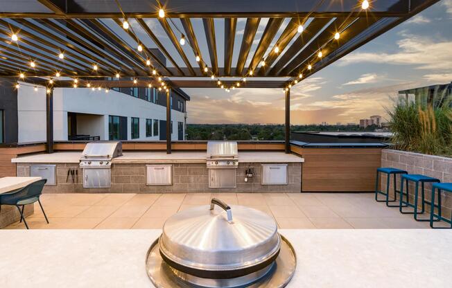 Rooftop grilling area and outdoor kitchen featuring mountain views.