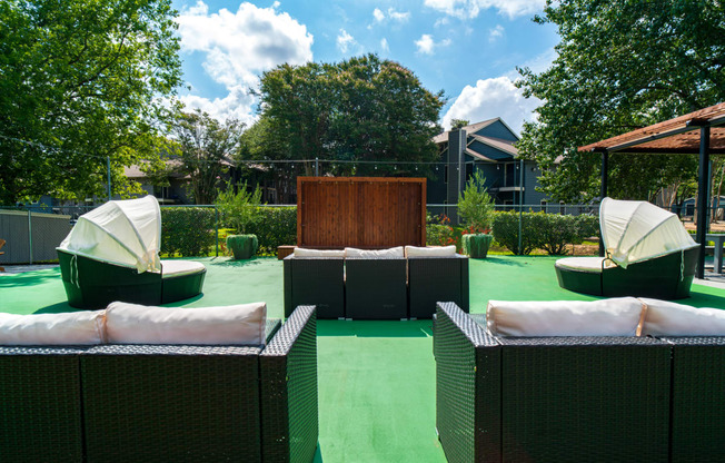 an outdoor seating area with chairs and umbrellas