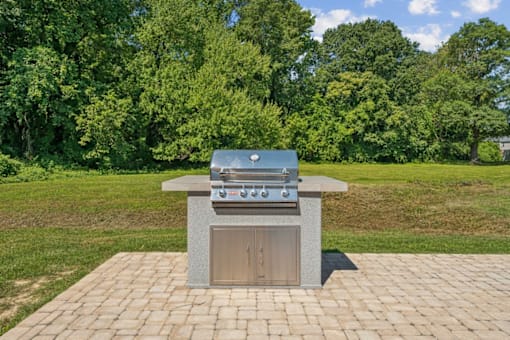 A brick patio with a built in BBQ grill at Staples Mill Townhomes Apartments, Richmond, Virginia