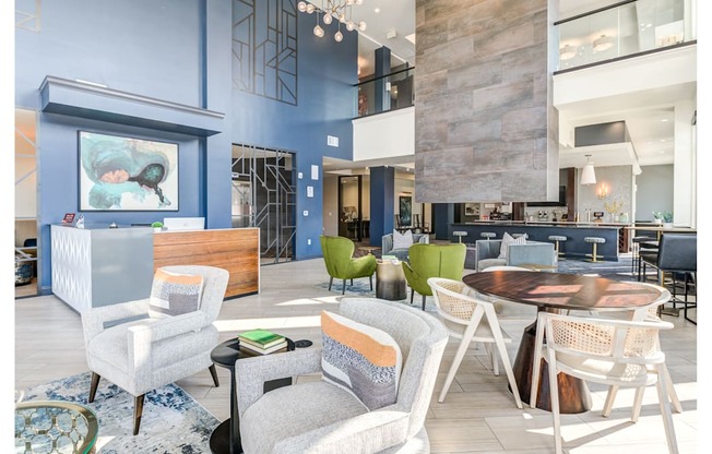 A modern living room with a blue accent wall and a variety of seating options.
