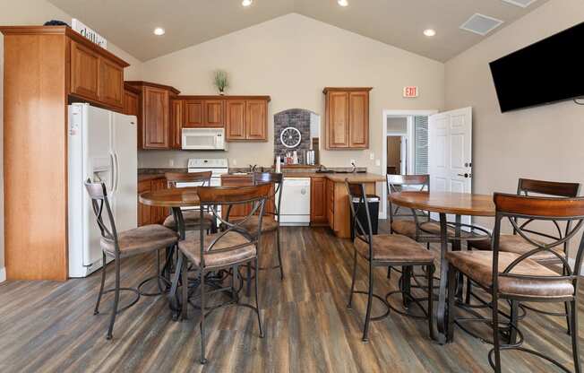 a kitchen and dining area with a table and chairs