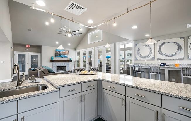 A kitchen with a granite countertop and a ceiling fan.