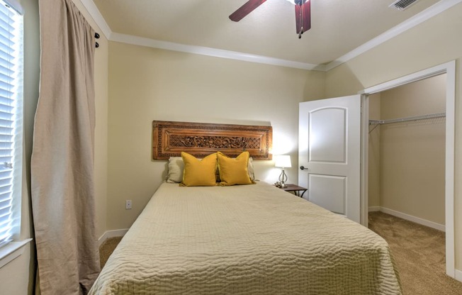 a bedroom with a large bed and a ceiling fan at Hacienda Club, Jacksonville, 32256