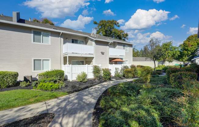 Community Grounds with walk paths, mature landscaping and views of the apartment buildings. 