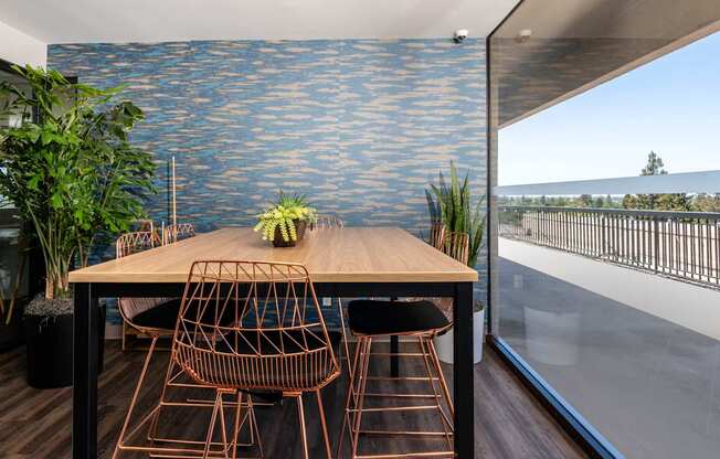 A dining table with chairs and a plant on it.