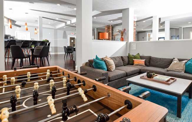 a recreation room with a foosball table and couches