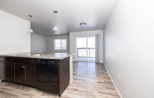 A kitchen with a sink and a window.