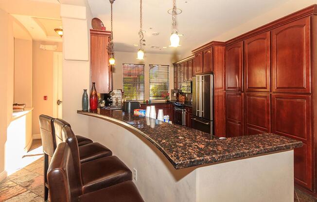 a large kitchen with stainless steel appliances and wooden cabinets