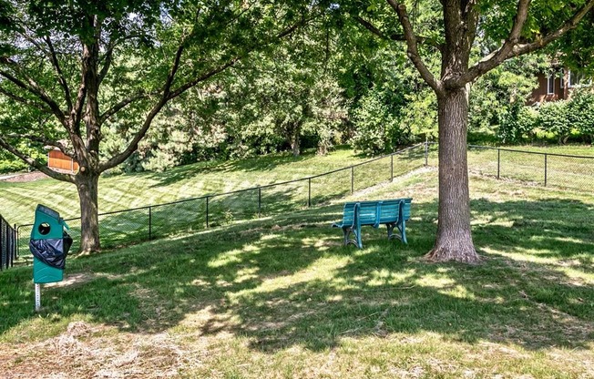 a park bench sitting next to a tree