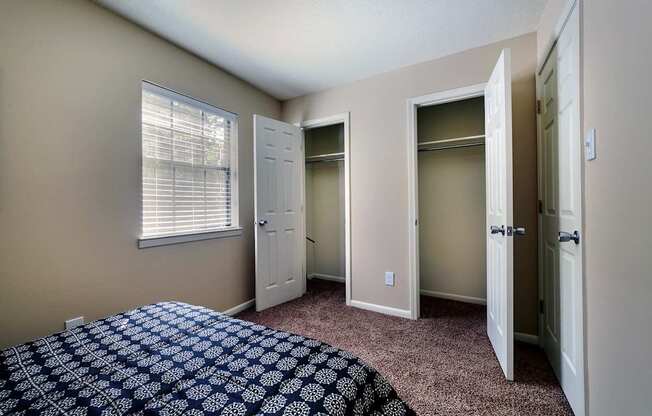 A bedroom with a bed and a window.