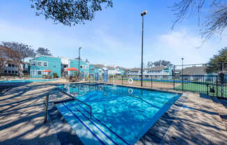 A blue swimming pool with a metal ladder on the left side.