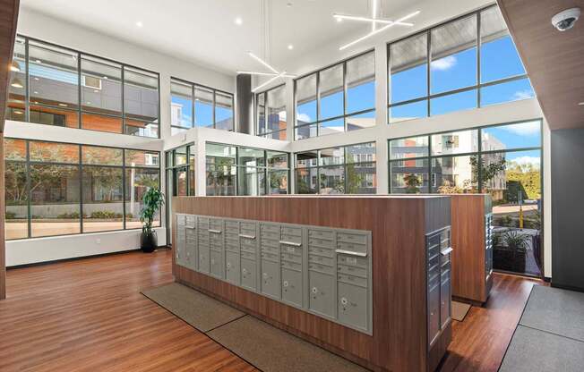 A reception area with a wooden desk and a large window.