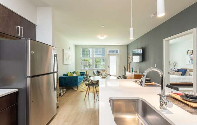 kitchen and living room at the district flats apartments in lenexa, ks
