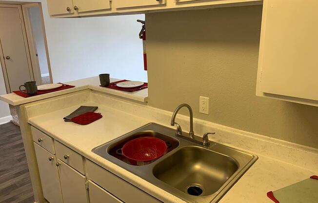 a stove top oven sitting next to a sink