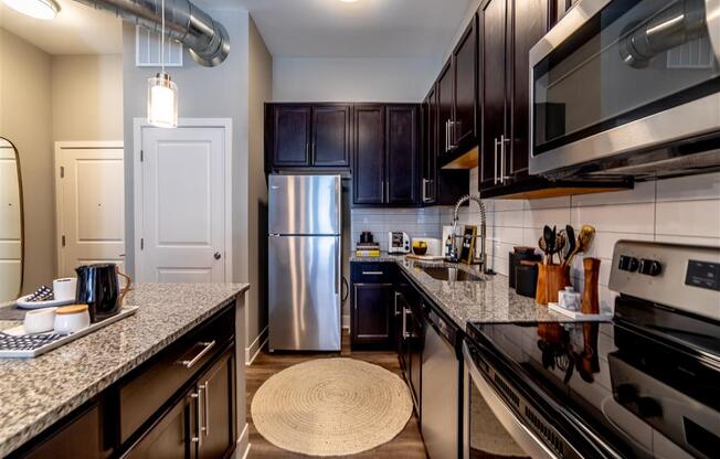 Fully Equipped Kitchen Includes Frost-Free Refrigerator, Electric Range, & Dishwasher at The Foundry, South Bend, 46617