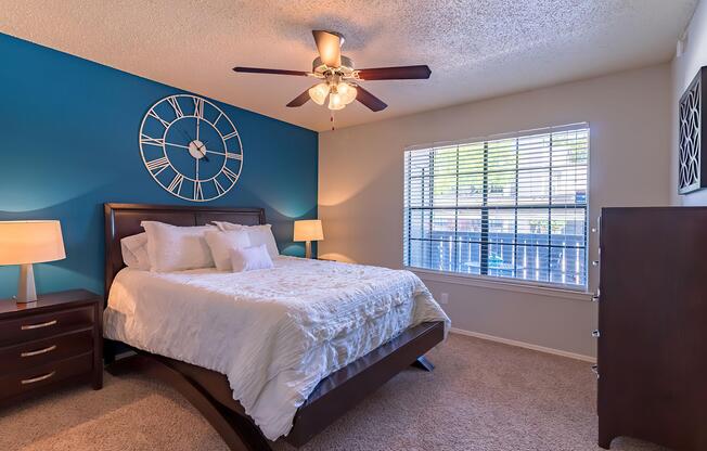a bedroom with a clock at the top of a bed