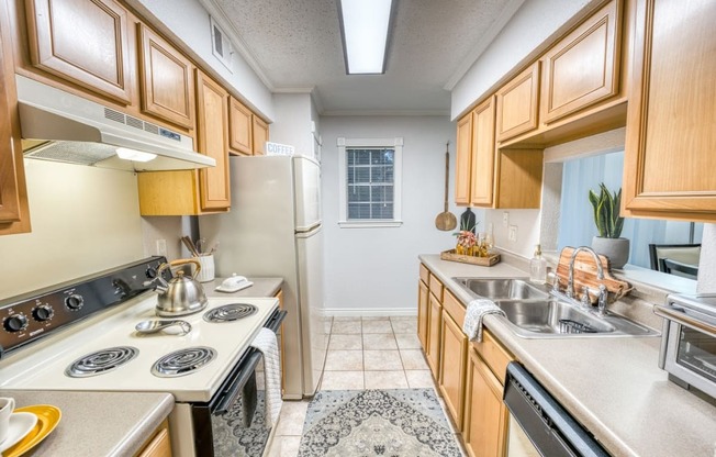 a kitchen with a stove top oven and a sink