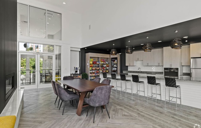 a dining room with a table and chairs and a kitchen