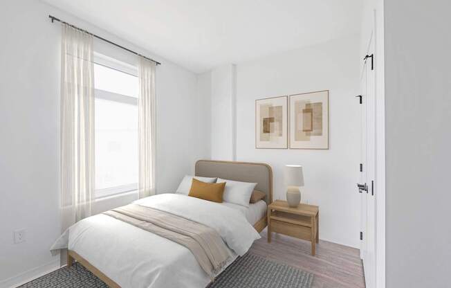A bedroom with a bed, nightstand, and pictures on the wall.