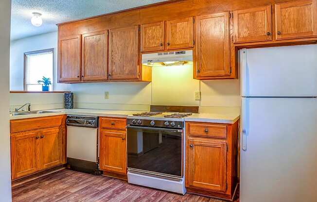 a kitchen with wooden cabinets and a white refrigerator