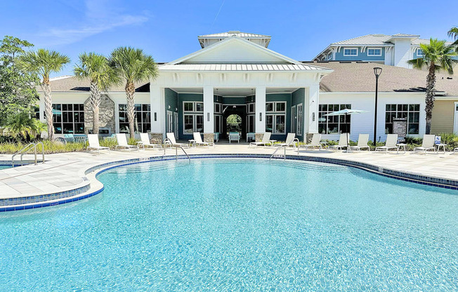 Beach-entry saltwater pool with splash pad, volleyball net, swim lane and cabanas