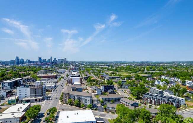 an aerial view of the city with the skyline in the distance