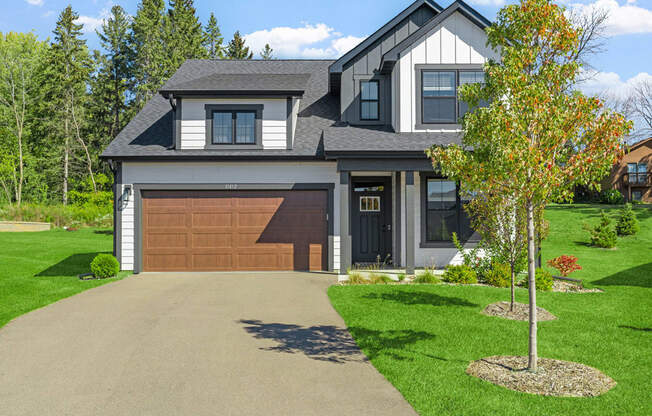 a house with a brown garage door and a driveway