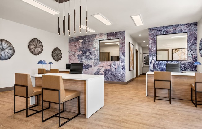 A reception area with a white counter and brown chairs.
