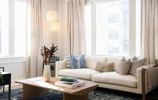 Cozy living room with giant windows and modern finishes at Novel Cary