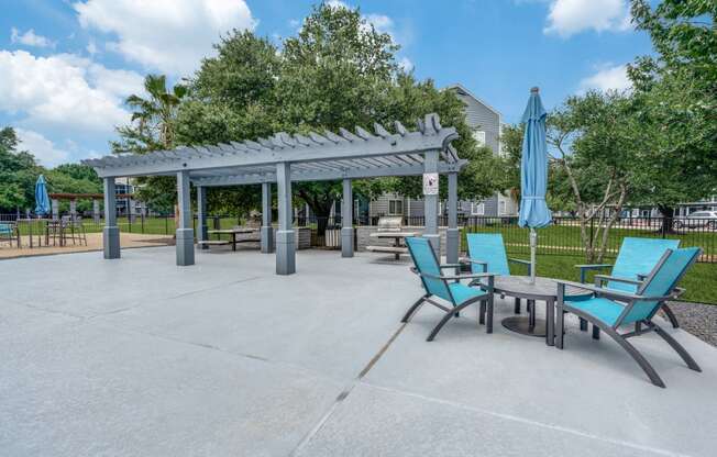 an outdoor patio with chairs and tables and a pavilion