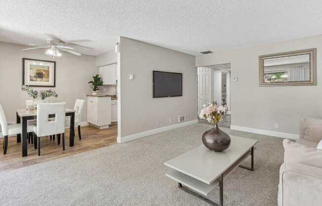 a living room with a couch and a table at Summerwood Apartments, Santa Clara, CA