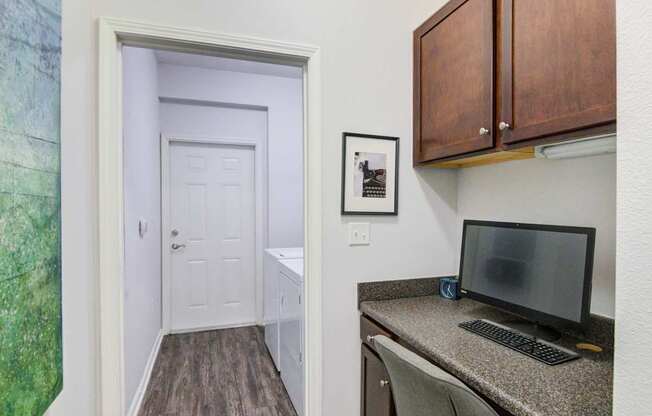 A room with a desk and a computer monitor.