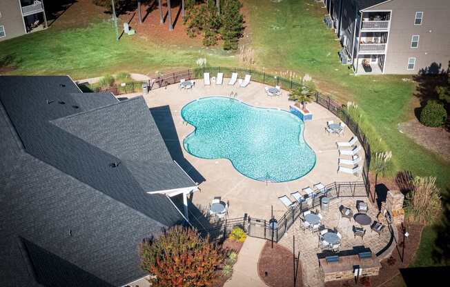 A small pool surrounded by a patio and deck.