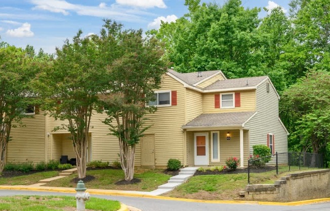 A house with a red door and a brown roof.
