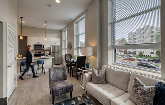 A woman walks through a modern living room.