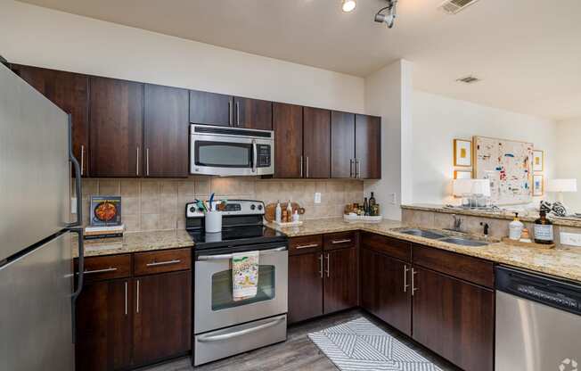 a kitchen with stainless steel appliances and granite counter tops