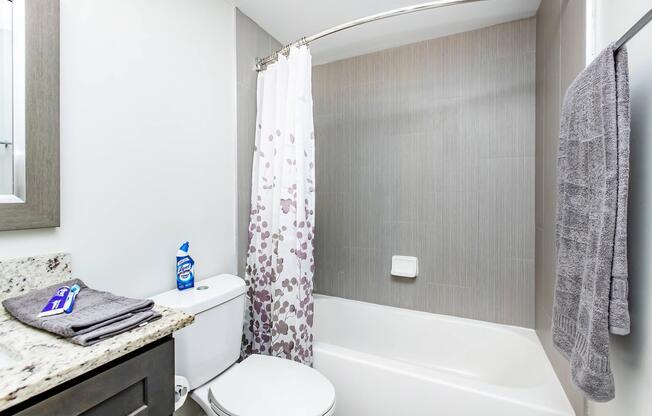 a shower curtain next to a sink