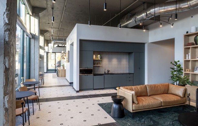 a living room with a couch and a kitchen at The Draper, St Louis, MO, 63103