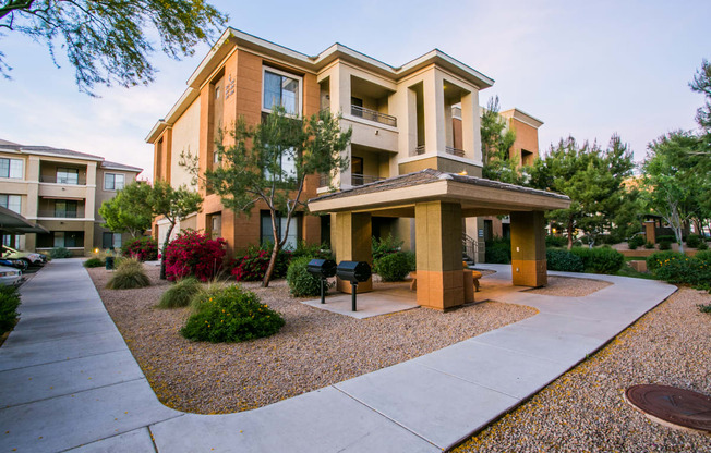 an apartment building with a walkway and a sidewalk