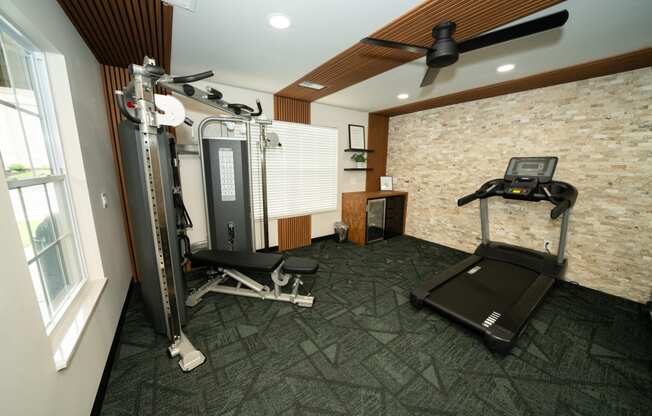 a home gym with exercise equipment and a window