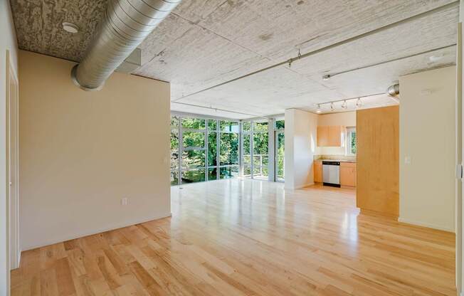 A room with wooden floors and a large window.
