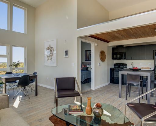 a living room with a glass table and chairs